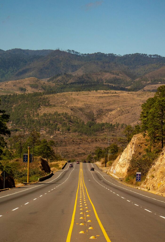A scenic highway stretching through the hilly landscape of Amarateca, Honduras.